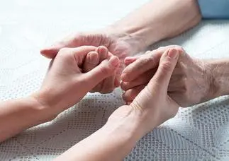 Doctor holding both hands of an elder patient