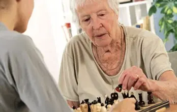 Senior Woman Playing Checkers Game